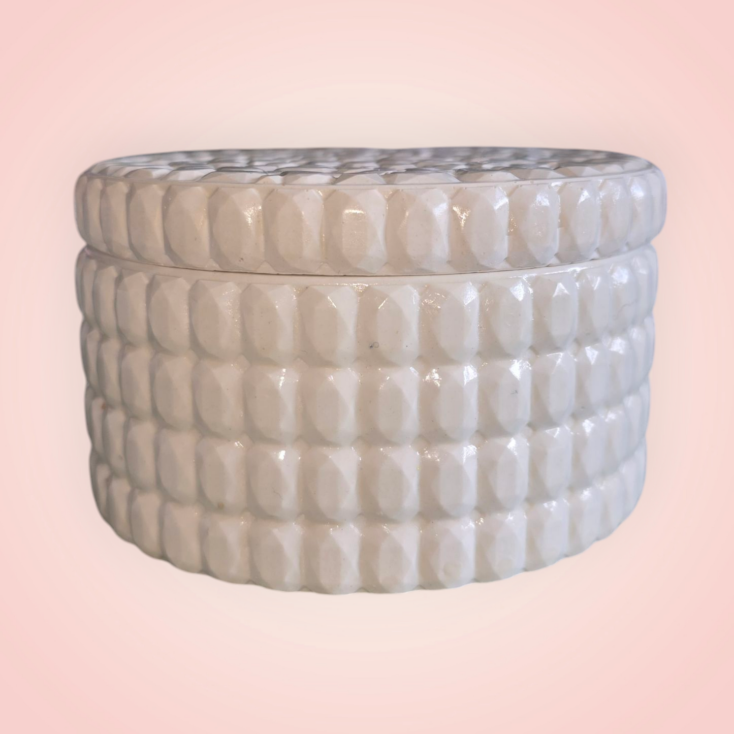Round soy wax candle vessel with lid.