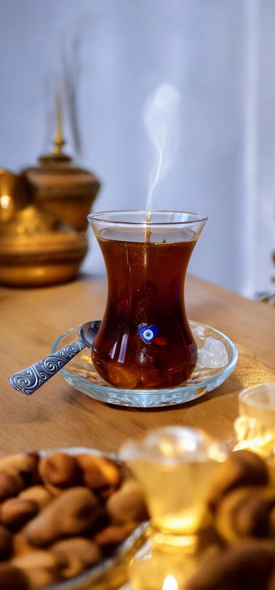 gel wax hand-poured iinto a turkish tea glass with spoon and tea plate.